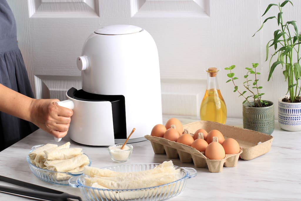 Woman cooking with airfryer